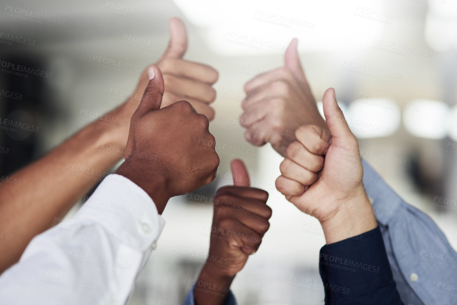 Buy stock photo Shot of a group of unidentifiable businesspeople showing thumbs up in the office