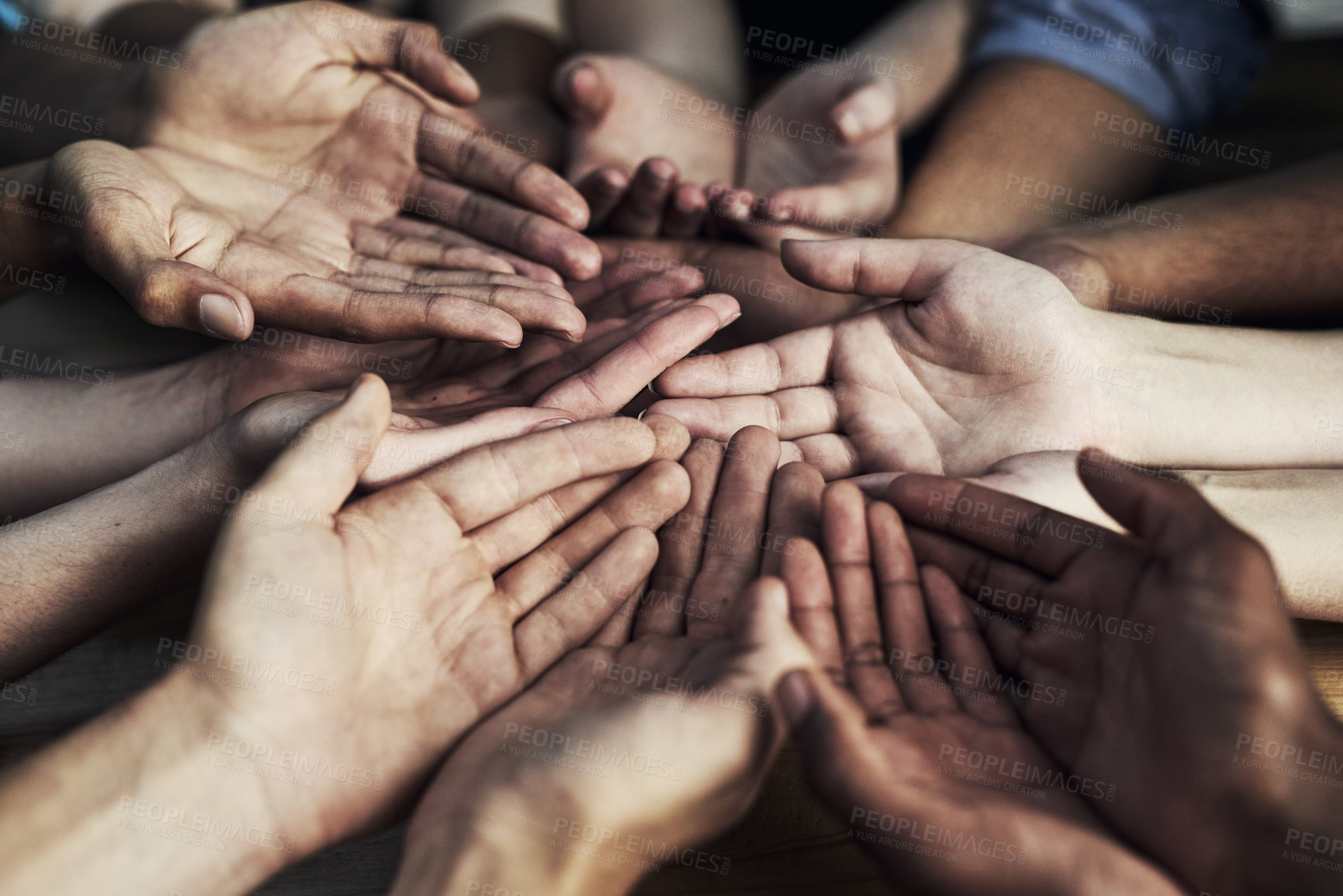 Buy stock photo Cropped shot of a large group of unidentifiable people cupping their hands together