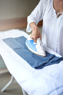 Buy stock photo Closeup of a woman ironing a shirt