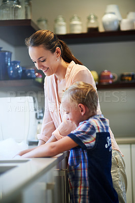 Buy stock photo Happy, mother and child in kitchen cleaning for education, development and family teamwork. Smiling, parent and kid working together for teaching, hygiene or learning healthy habits and bonding