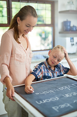 Buy stock photo Mother, child and writing with chalkboard for checklist, daily routine or activities at home. Woman, kid or son with smile taking notes on housekeeping chores, rules or duty with to do list at house