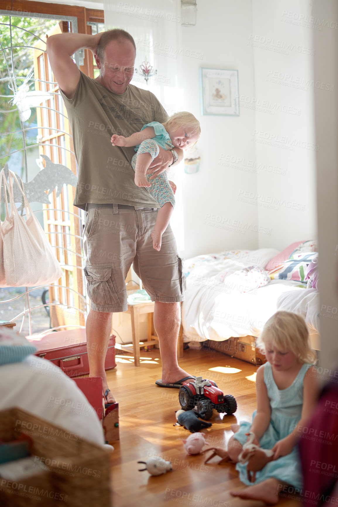 Buy stock photo Father, child and smile in home with stress or overwhelmed parenting for hyperactive adhd, siblings or development. Male person, daughters and laughing in bedroom as single dad, toys or housework