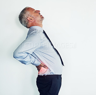 Buy stock photo Studio shot of a mature man experiencing muscular strain