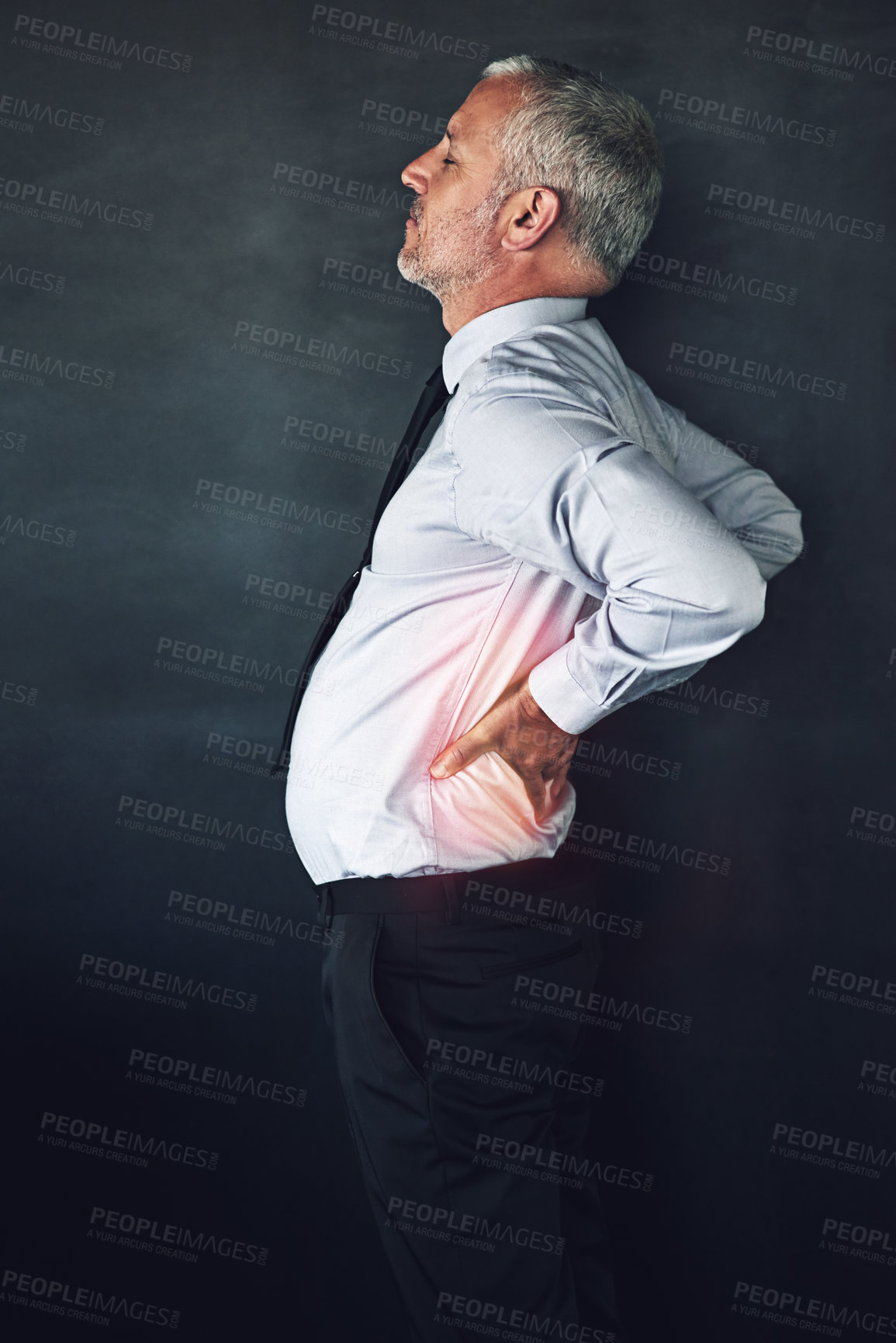 Buy stock photo Mature, back pain and business man in studio with tension for burnout, medical crisis and anxiety. Red glow overlay, overworked and person with muscle strain, accident and injury on gray background