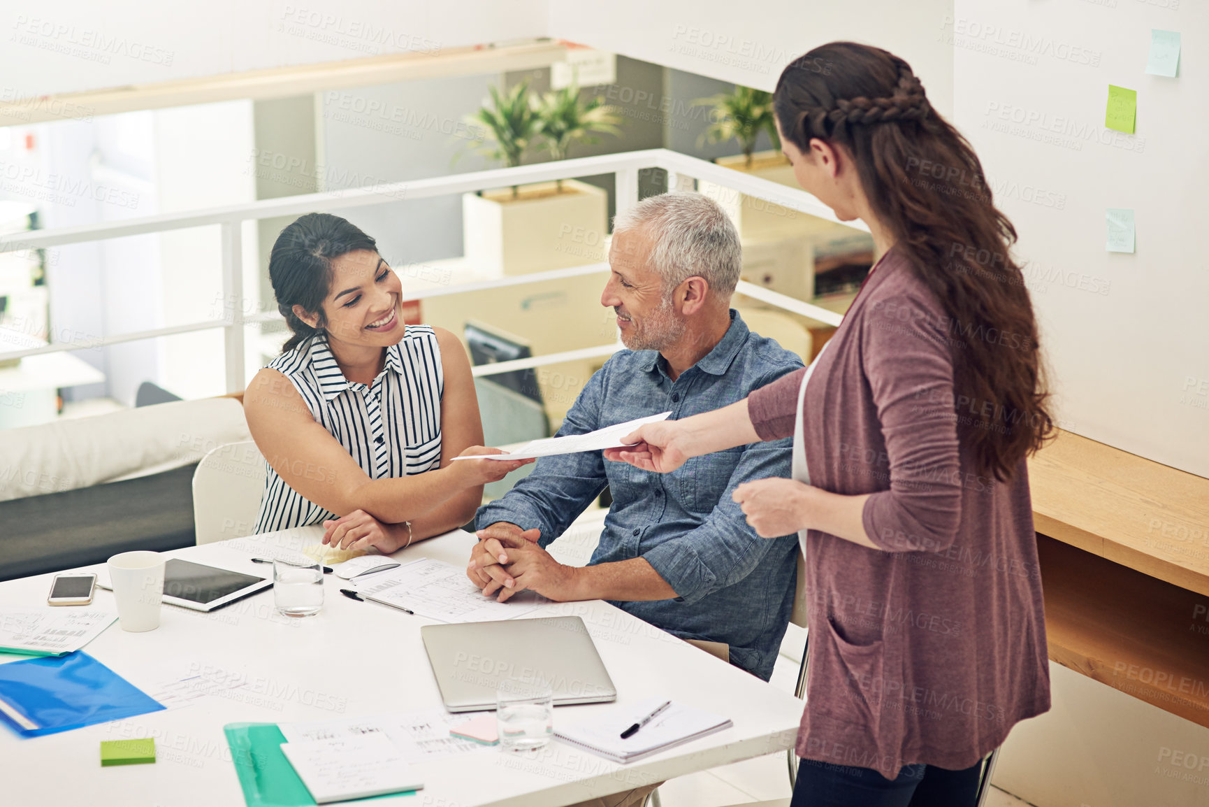 Buy stock photo Shot of a team of colleagues having a meeting in a modern office