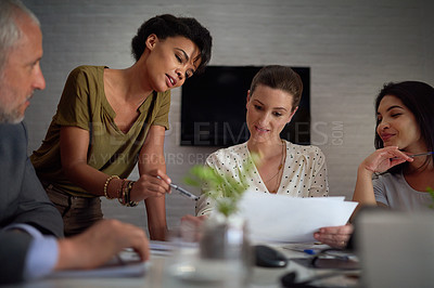 Buy stock photo Shot of a group of colleagues working late in an office