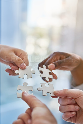 Buy stock photo Shot of hands putting puzzle pieces together