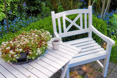 Buy stock photo Cozy secluded area for coffee and reading. High angle closeup of wooden white patio furniture in a garden outdoors. Private location to relax and enjoy alone time in the warm summer weather outside