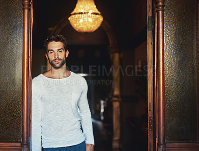 Buy stock photo Portrait of a handsome man dressed in casual wear posing in a doorway