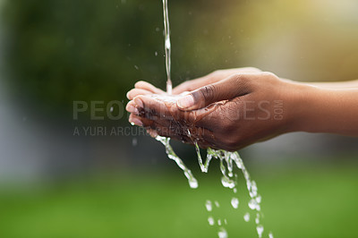 Buy stock photo Cropped shot of a woman washing her hands outdoors