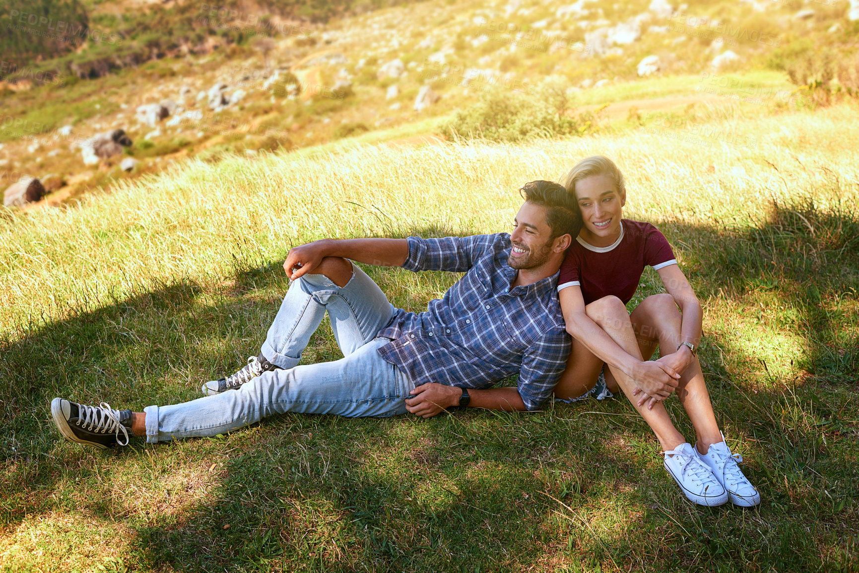 Buy stock photo Shot of an affectionate young couple enjoying a day outdoors