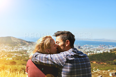 Buy stock photo Shot of an affectionate young couple enjoying a day outdoors