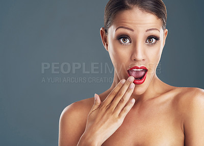 Buy stock photo Studio portrait of a beautiful young woman looking surprised against a grey background