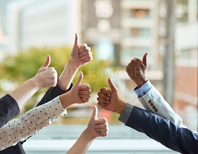 Buy stock photo Cropped shot of a group of businesspeople showing a thumbs up gesture