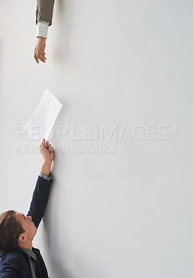 Buy stock photo Shot of a businessman passing on a document to a colleague in an office