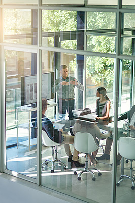 Buy stock photo Shot of a group of businesspeople meeting in the boardroom