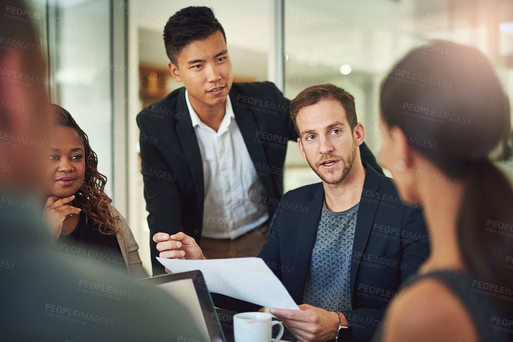 Buy stock photo Shot of a group of businesspeople meeting in the boardroom