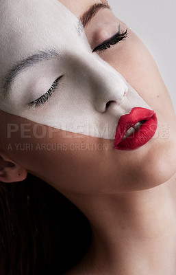 Buy stock photo Closeup of a beautiful woman wearing face paint and red lipstick