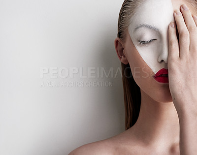 Buy stock photo Shot of a beautiful woman wearing face paint and red lipstick against a plain background