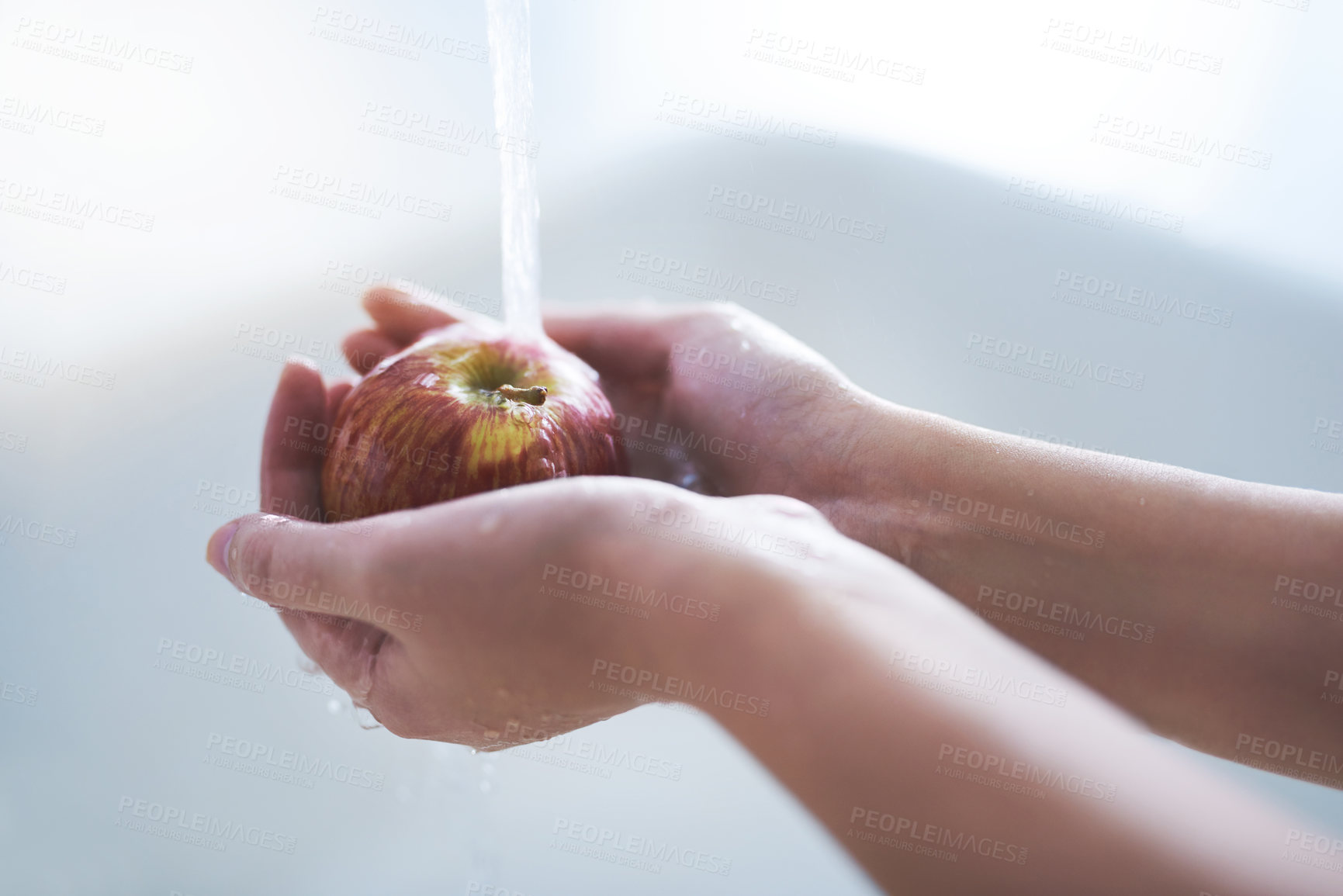 Buy stock photo Water, hands and person washing apple, hygiene in kitchen with  sustainability and disinfection, germs or bacteria. Health, wellness and nutrition with fruit, organic and food with splash at home