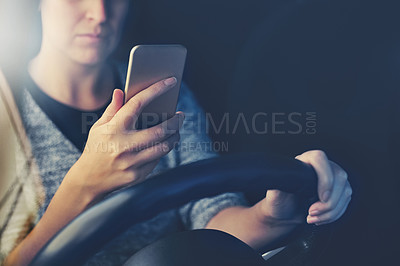 Buy stock photo Shot of a woman using a phone while driving