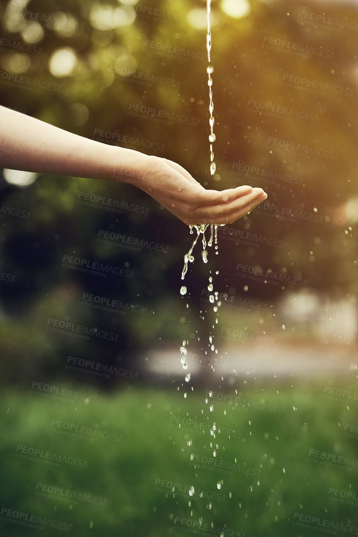 Buy stock photo Cropped shot of water running on a woman's hand outside
