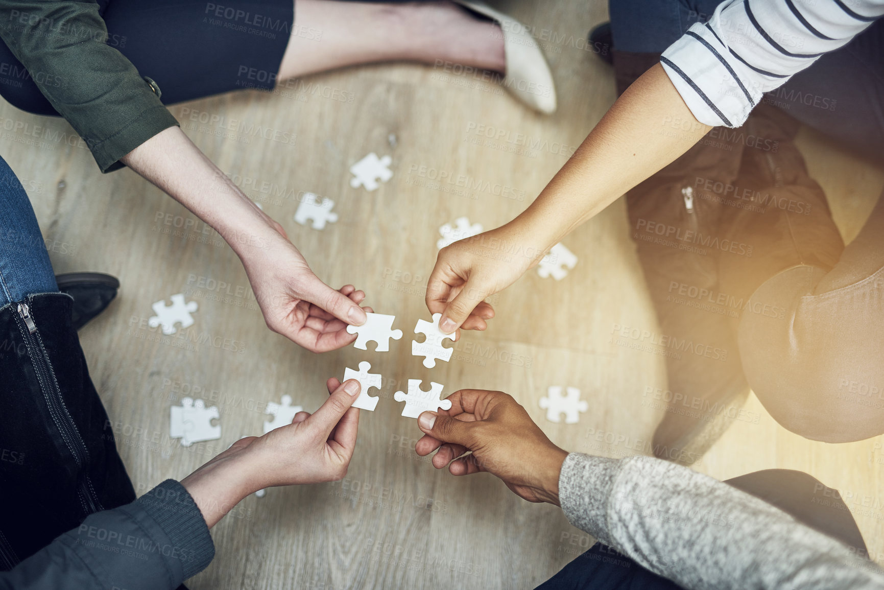 Buy stock photo People, support and hands with puzzle on floor for problem solving, strategy and synergy in training. Team, diversity and partnership with jigsaw for collaboration, growth and creative development