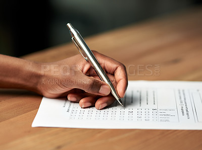 Buy stock photo Shot of a person filling in some paperwork