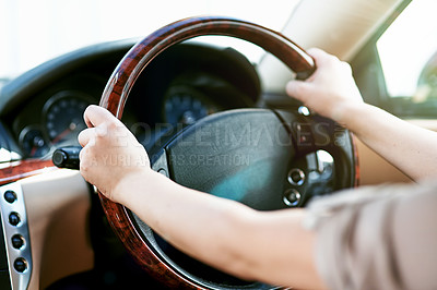 Buy stock photo Hands of a driver on a steering wheel in a car for travel, driving or taking a roadtrip. Take a drive in a taxi, cab or with a rideshare service. Closeup of a limousine chauffeur practicing safety