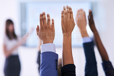 Buy stock photo Shot of a group of people raising their hands in a class