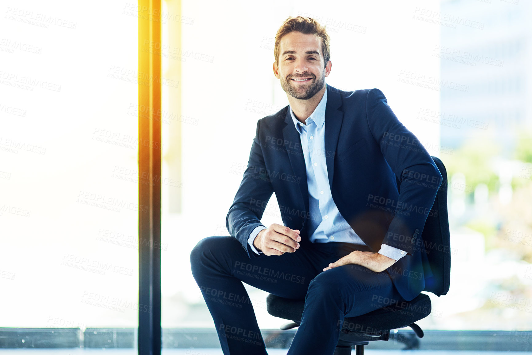 Buy stock photo Portrait of a young businessman sitting in an office