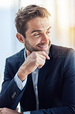 Buy stock photo Shot of a young businessman sitting in an office
