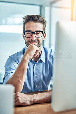 Buy stock photo Portrait of a young businessman sitting at an office desk