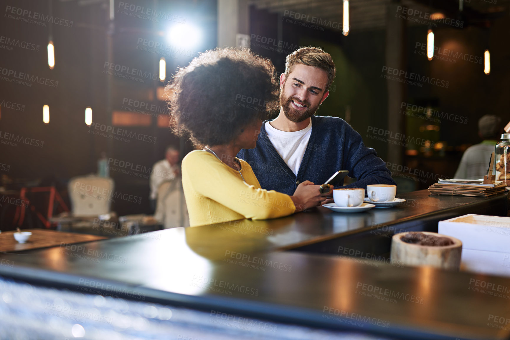 Buy stock photo Shot of two people using a digital tablet in a cafe