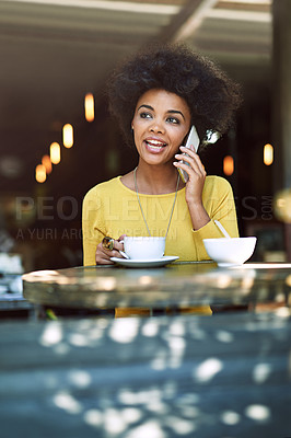 Buy stock photo Shot of a young woman talking on a cellphone in a cafe