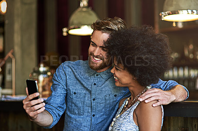 Buy stock photo Shot of two people taking a selfie in a cafe