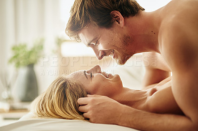Buy stock photo Shot of a young couple sharing an intimate moment  in bed