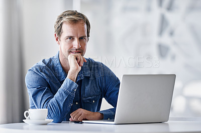 Buy stock photo Portrait of a mature businessman using a laptop while sitting at a desk in an office