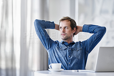 Buy stock photo Shot of a thoughtful mature businessman using a laptop while sitting at a desk in an office