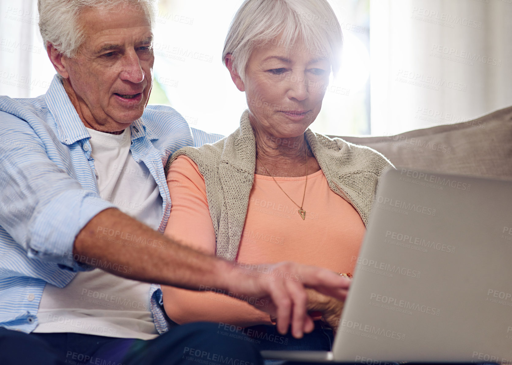 Buy stock photo Shot of a senior couple using a laptop at home