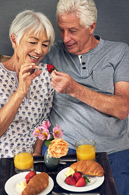 Buy stock photo Shot of a senior couple having breakfast in bed