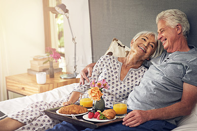 Buy stock photo Shot of a senior couple having breakfast in bed