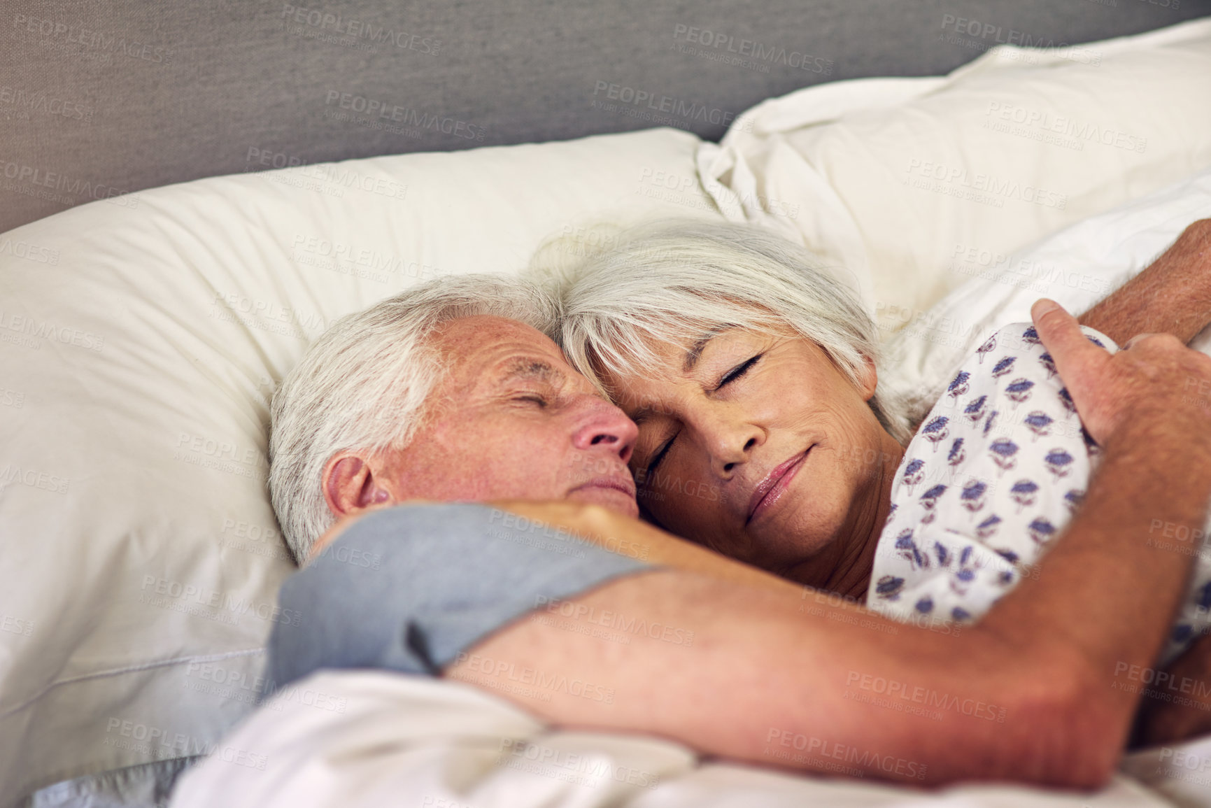 Buy stock photo Shot of a senior couple sleeping in bed