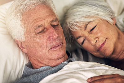 Buy stock photo Shot of a senior couple sleeping in bed