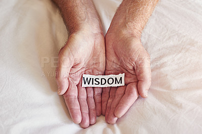 Buy stock photo Cropped shot of a person holding a piece of paper with the word wisdom written on it