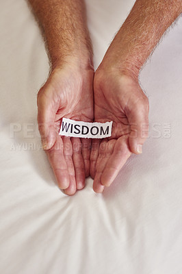 Buy stock photo Cropped shot of a person holding a piece of paper with the word wisdom written on it