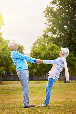 Buy stock photo Shot of a senior couple enjoying the day together in a park