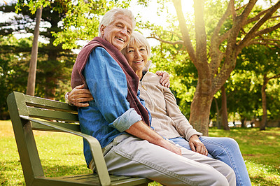 Buy stock photo Portrait of a happy senior couple sitting on a park bench