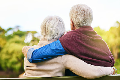 Buy stock photo Rearview shot of a senior couple sitting on a park bench