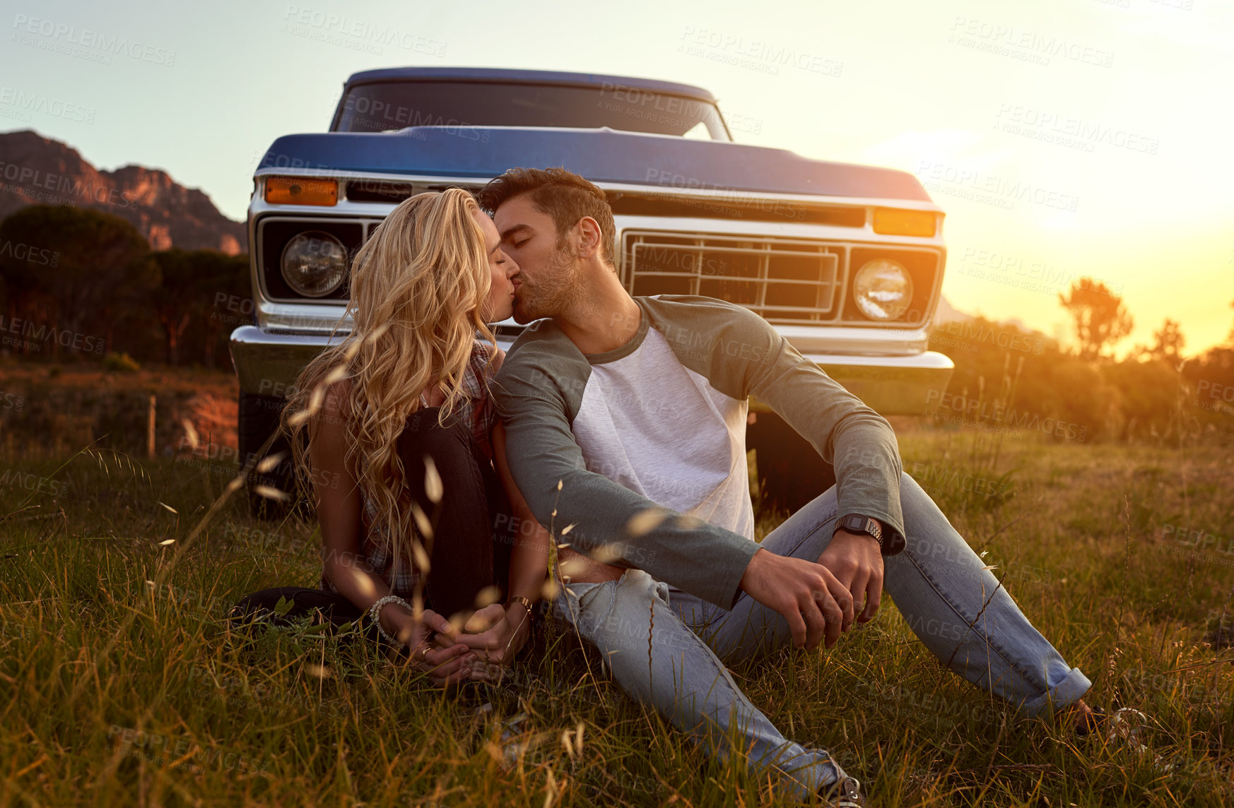 Buy stock photo Shot of an affectionate young couple on a roadtrip